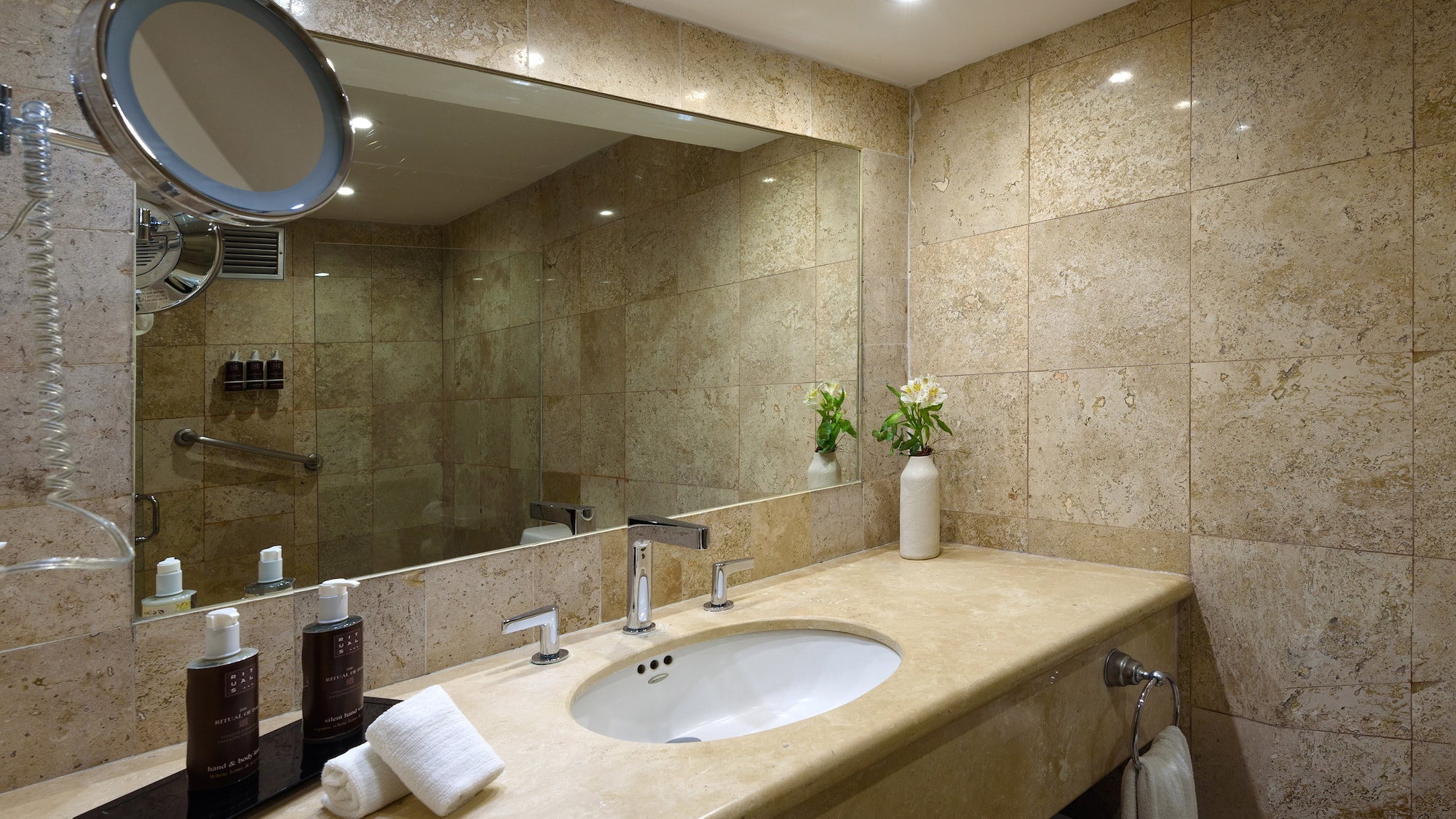 a bathroom with a large mirror and a sink