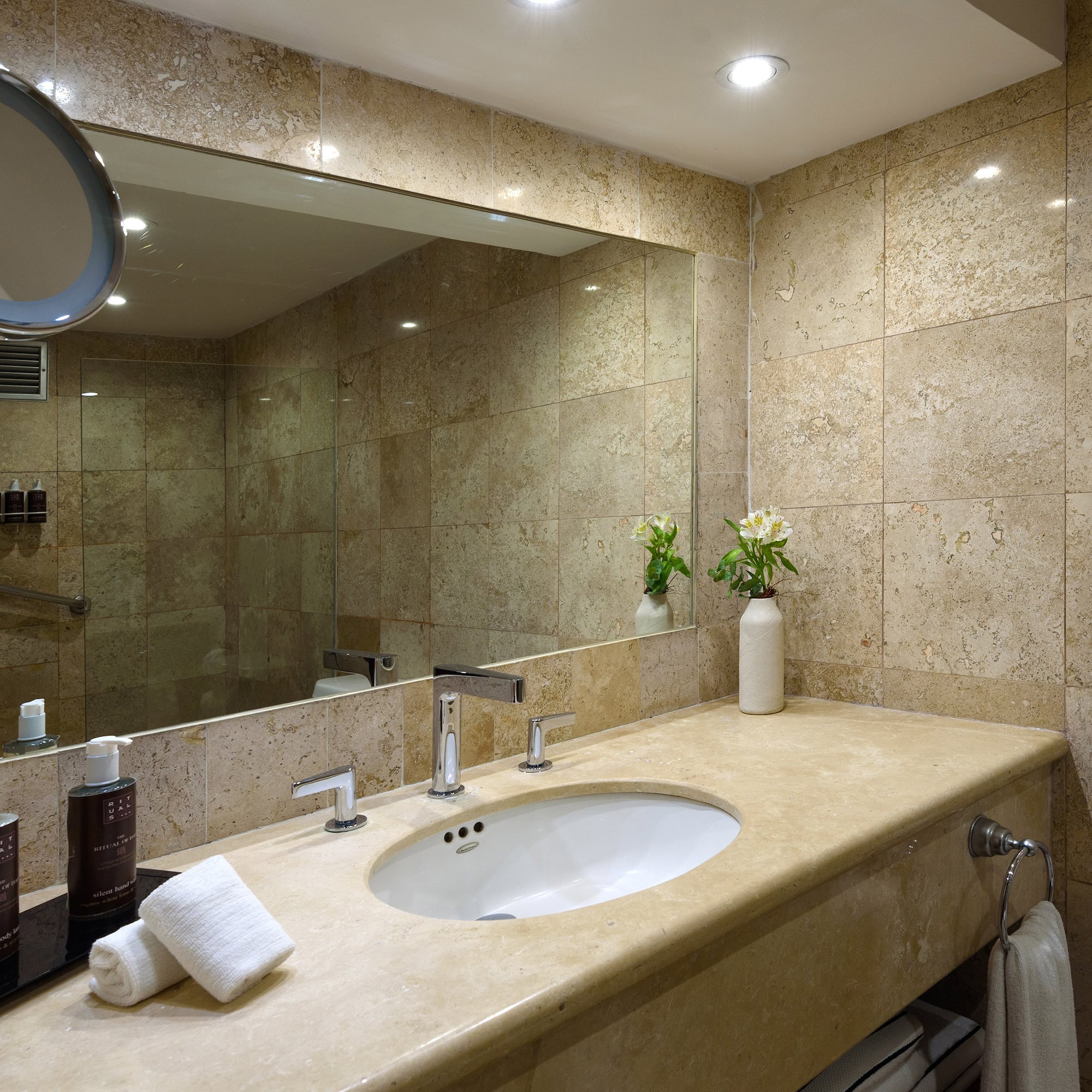 a bathroom with a large mirror and a sink