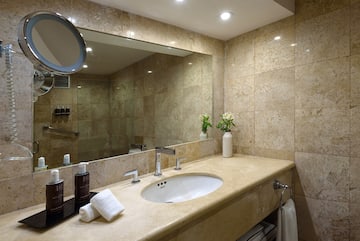 a bathroom with a large mirror and a sink
