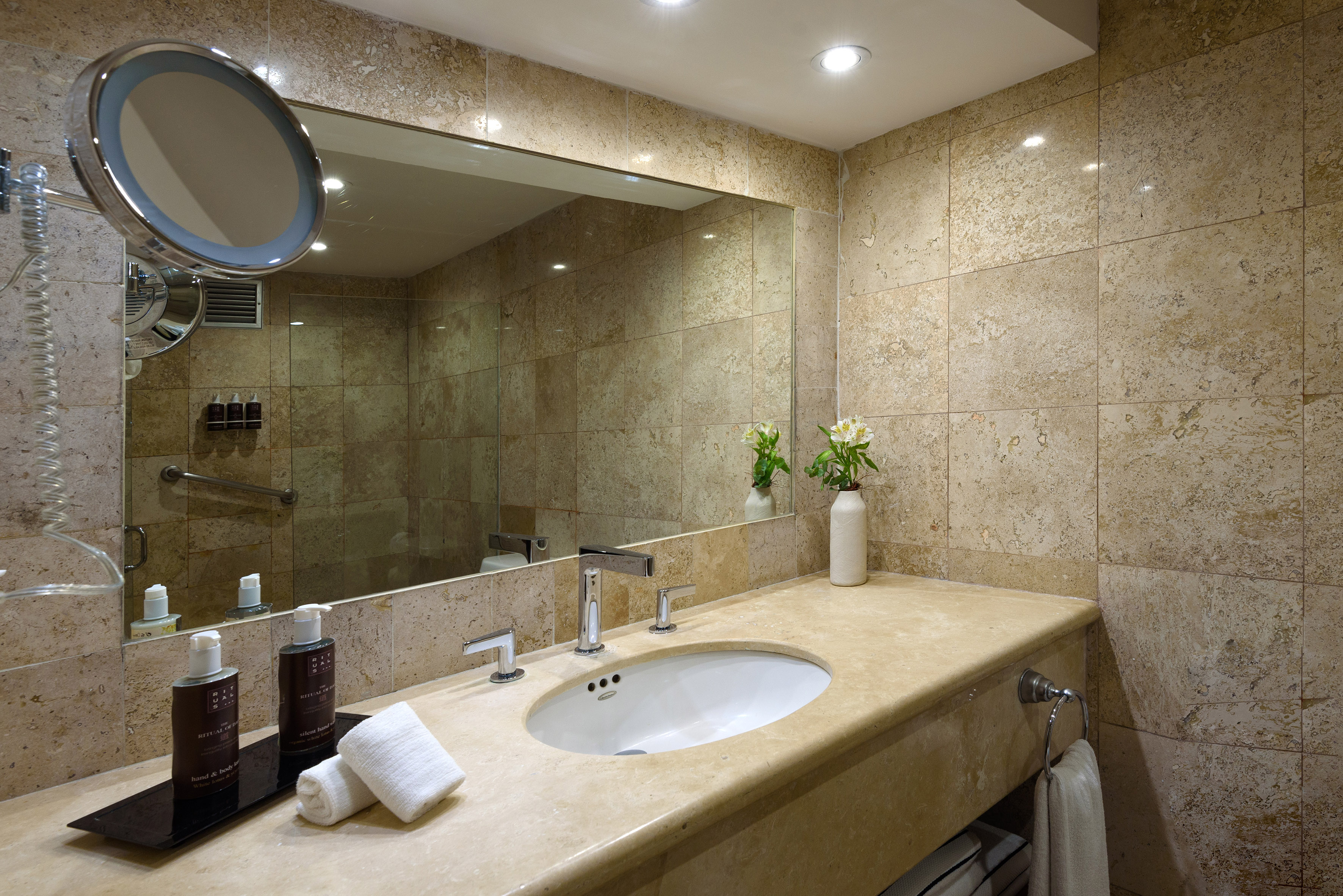a bathroom with a large mirror and a sink
