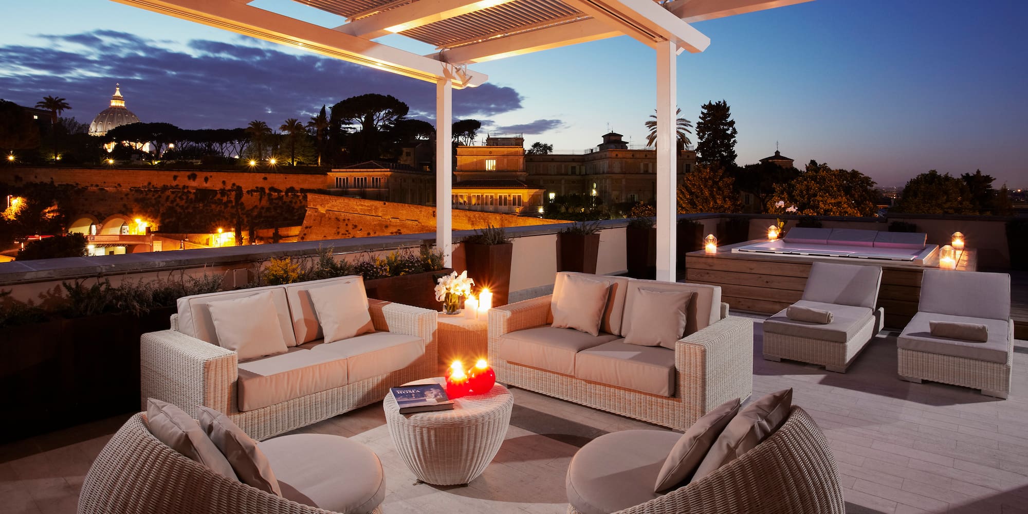a patio with a hot tub and furniture