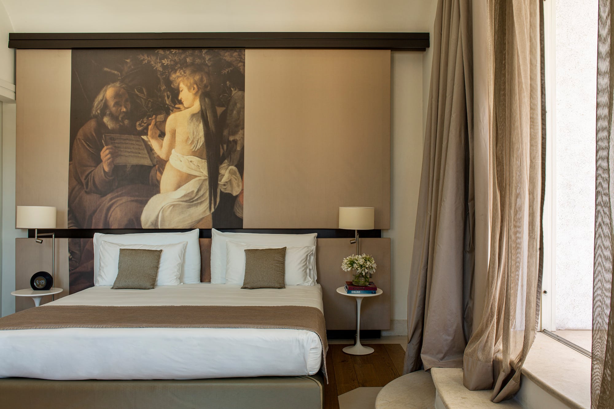 a bed with a large painting above it
