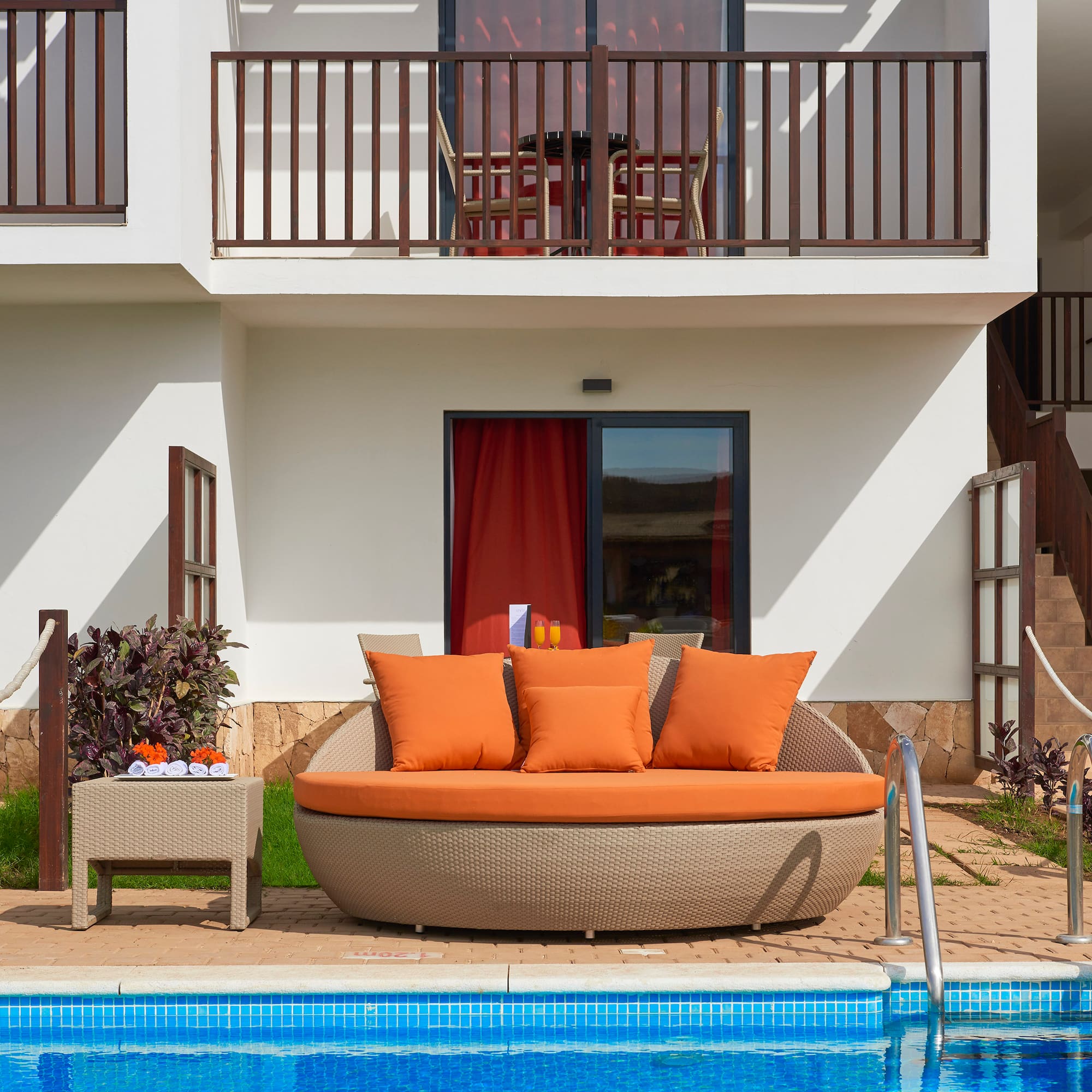 a pool with a couch and a table