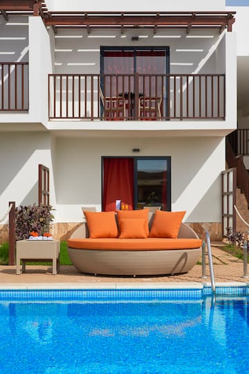 a pool with a couch and a table
