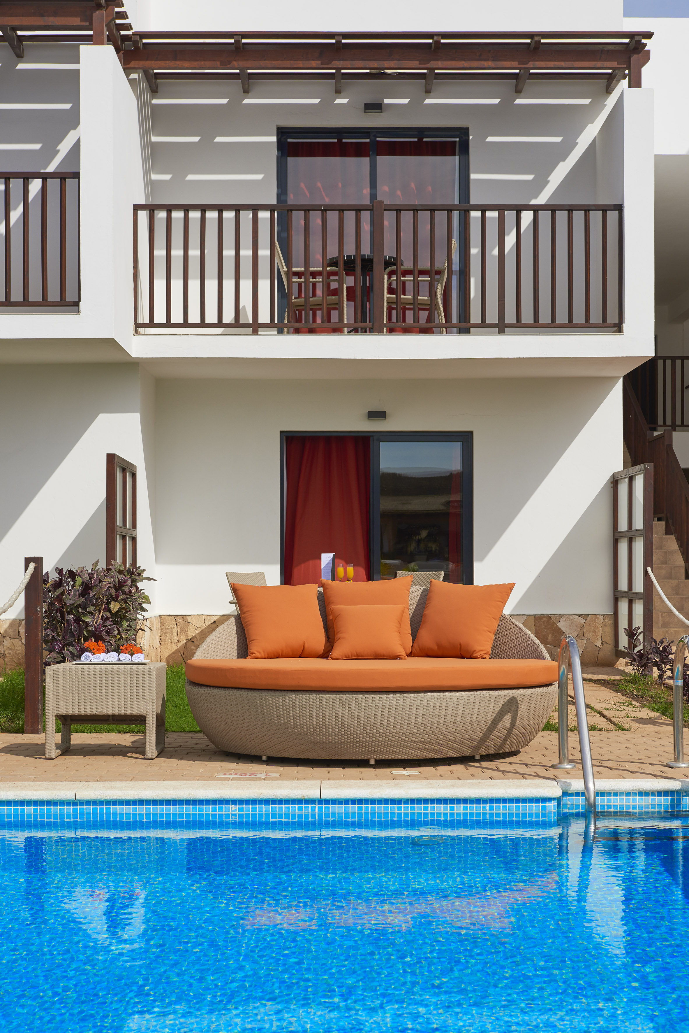 a pool with a couch and a table