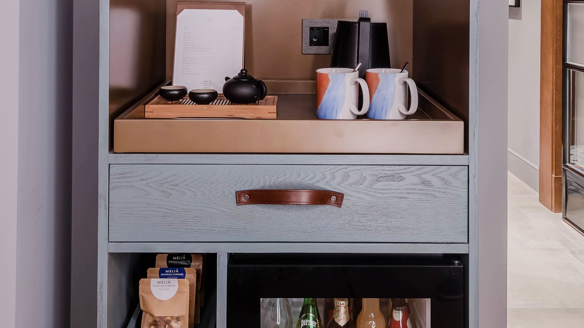 a shelf with a small refrigerator and a small beverage cabinet