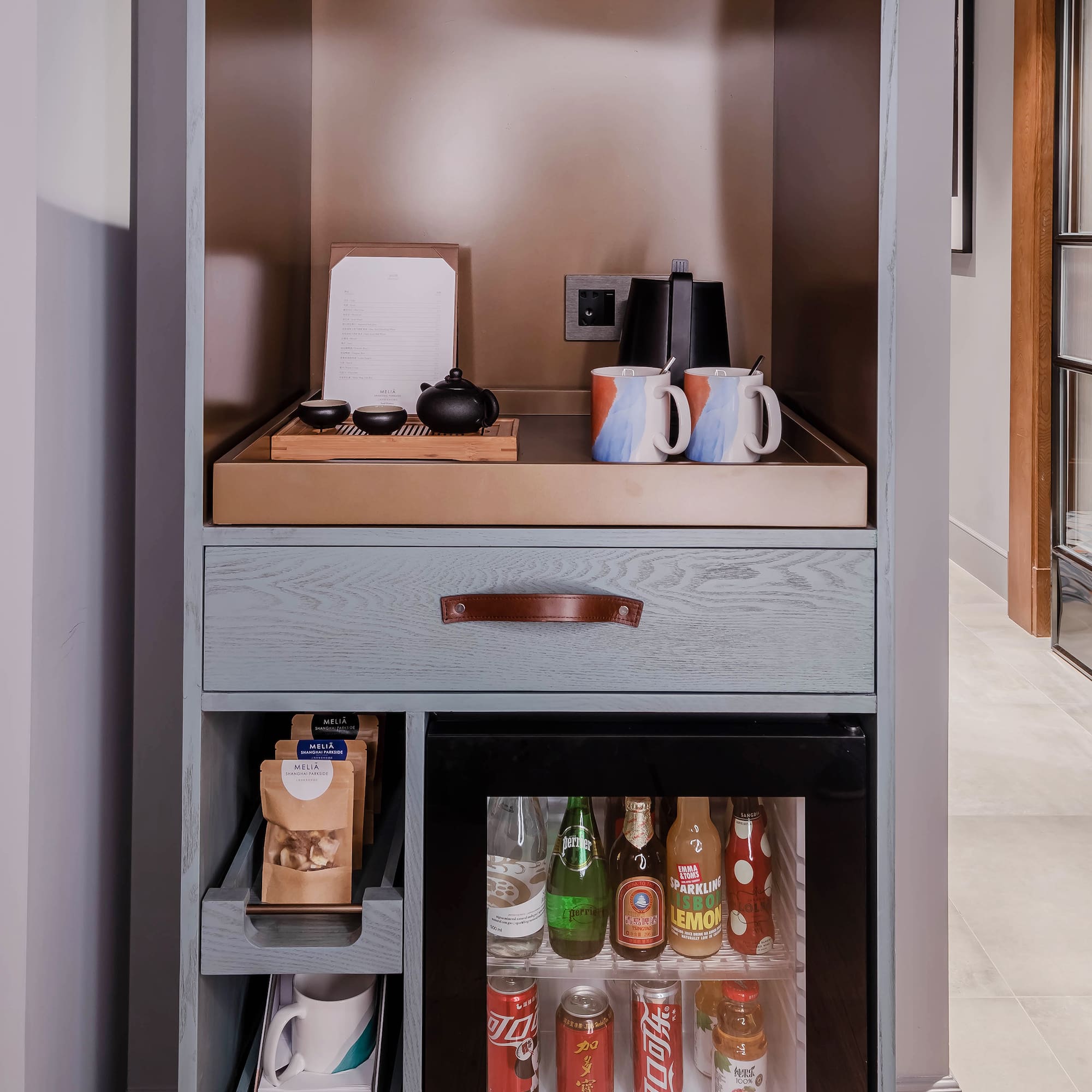 a shelf with a small refrigerator and a small beverage cabinet