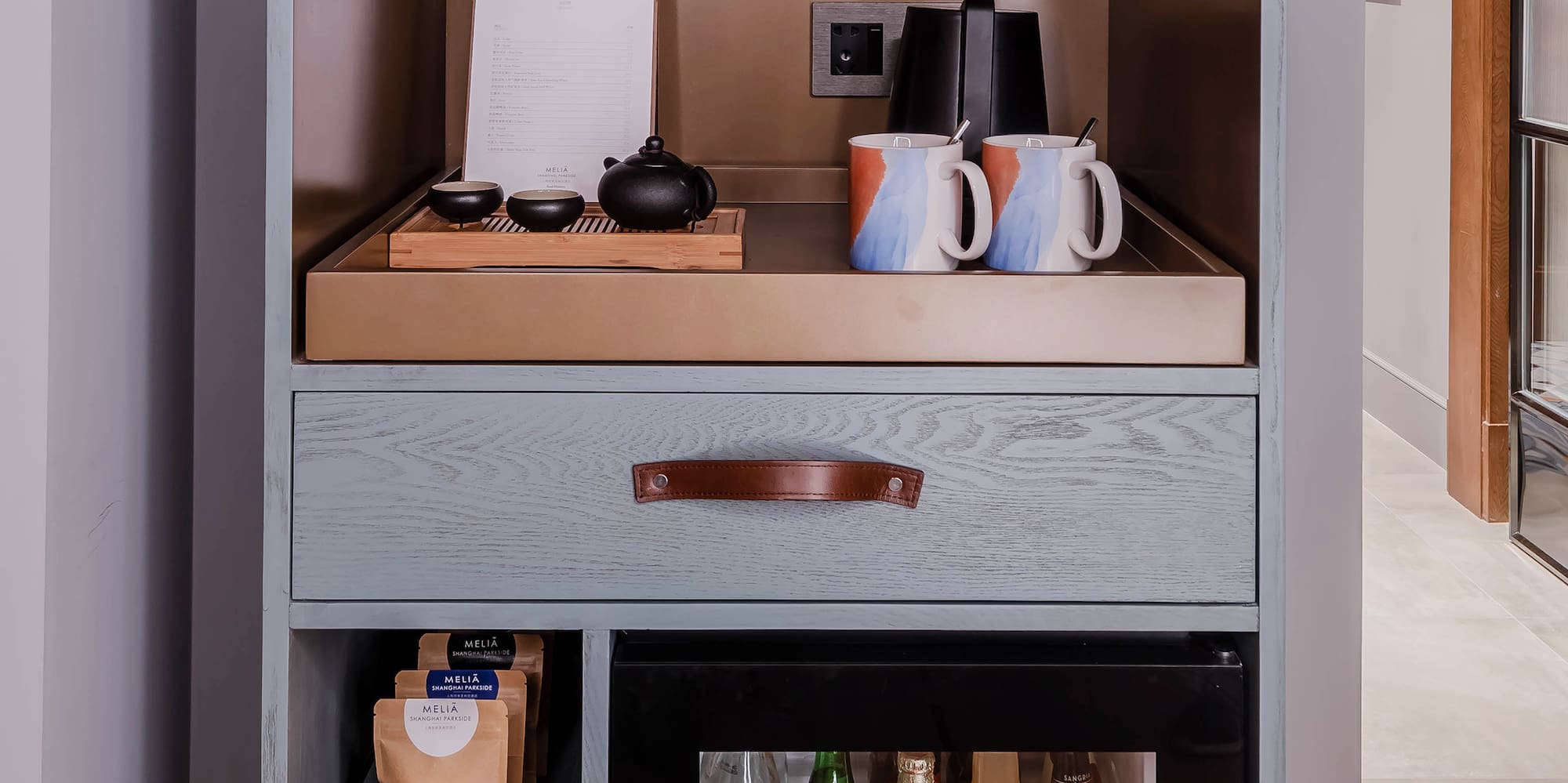 a shelf with a small refrigerator and a small beverage cabinet