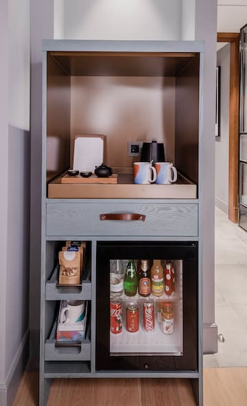 a shelf with a small refrigerator and a small beverage cabinet
