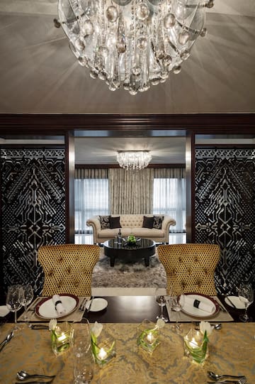 a dining room with a chandelier and a couch