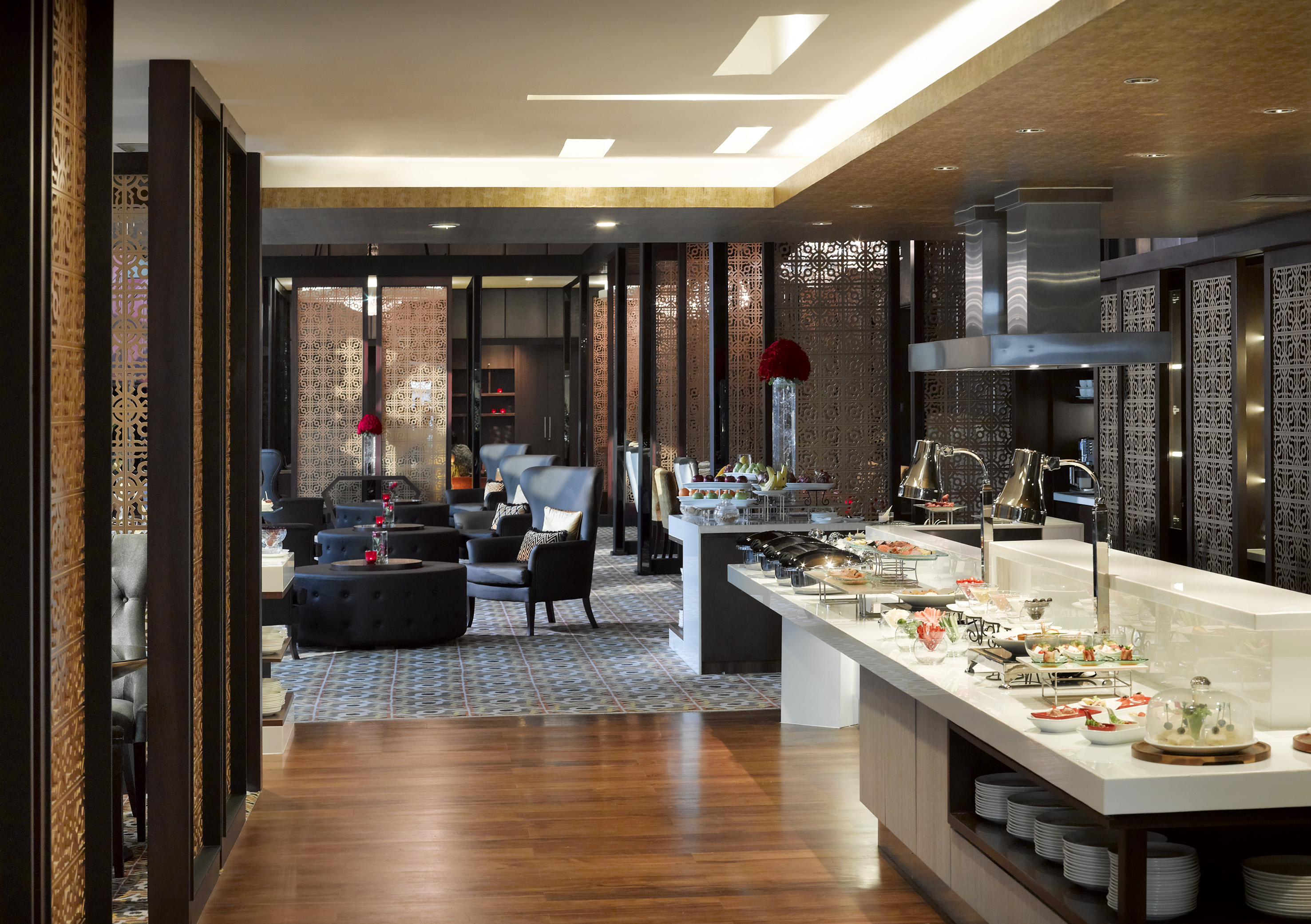 Elegant hotel buffet with lounge seating and ornate screens.