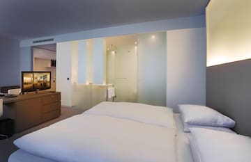 a room with a bed and a dresser