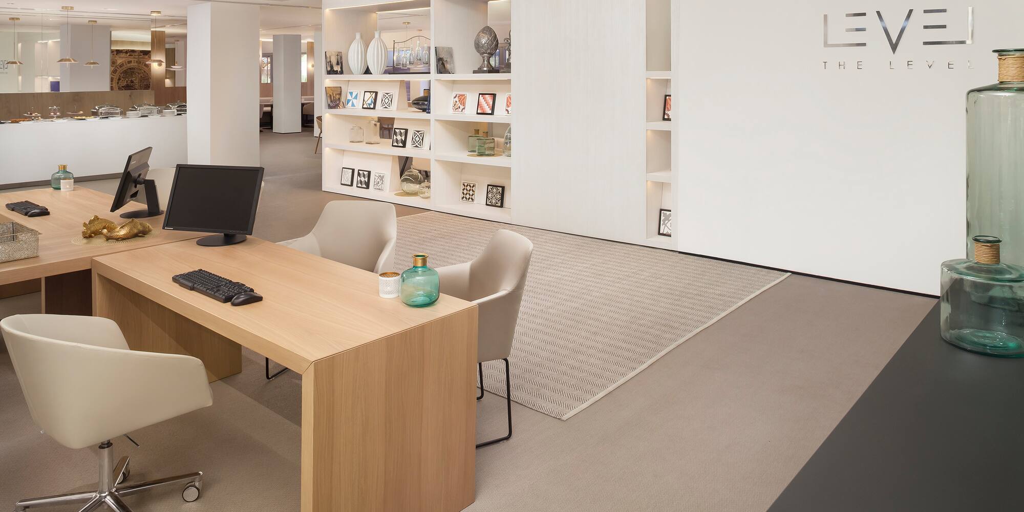 a room with a computer desk and a white wall