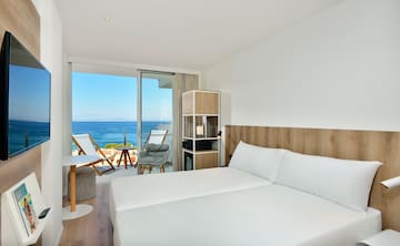 a room with a large bed and a glass door