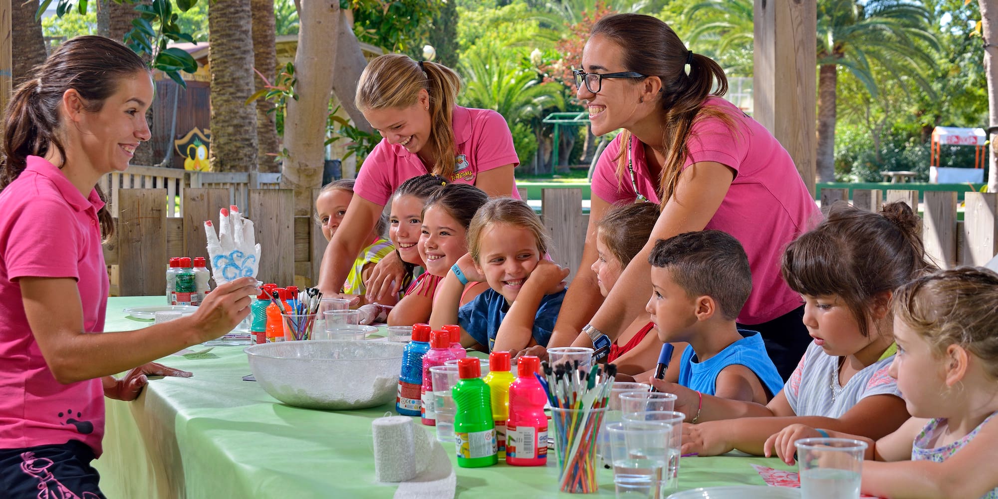 a group of children sitting around a table