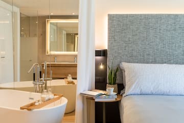 a bedroom with a bed and a bathtub