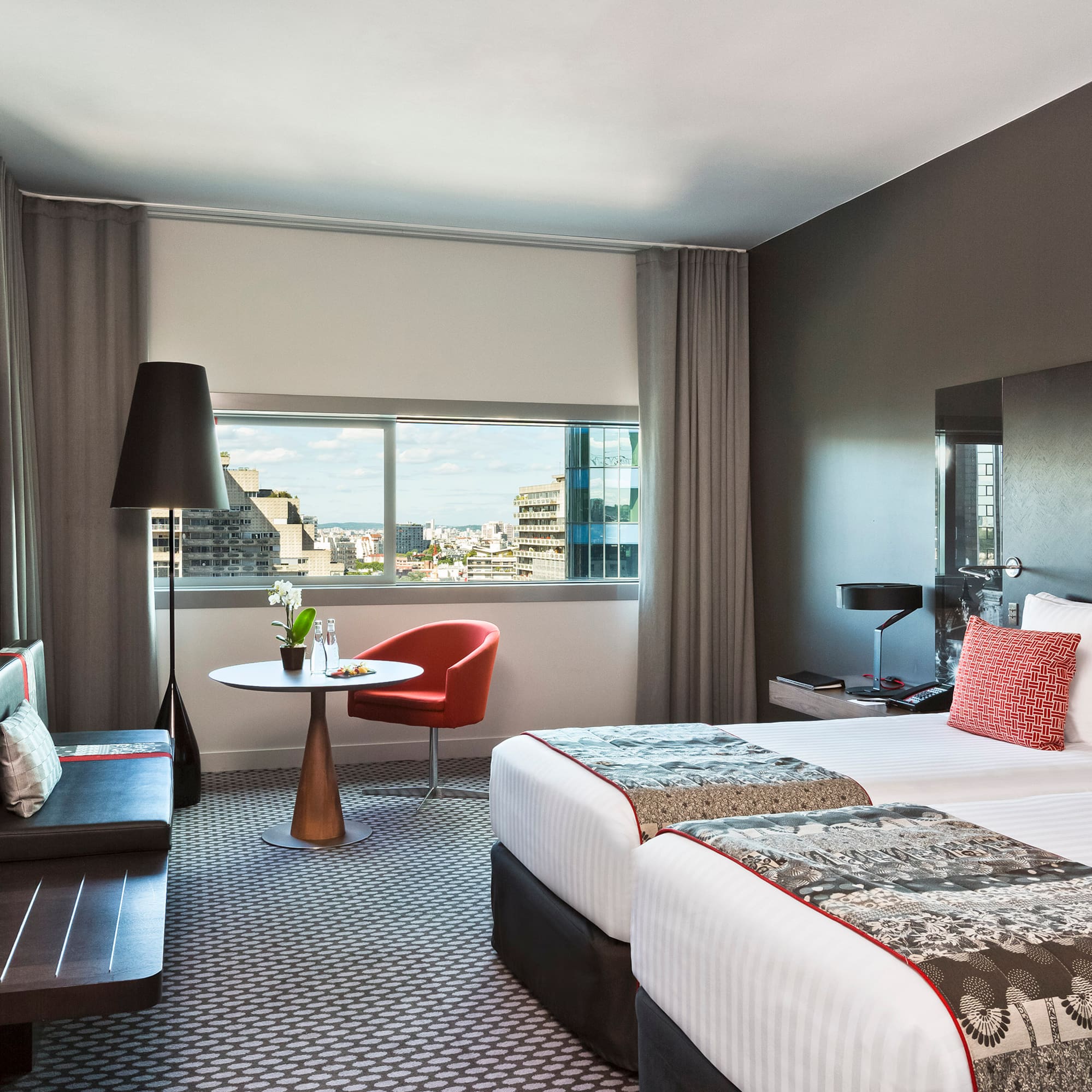 a room with two beds and a table