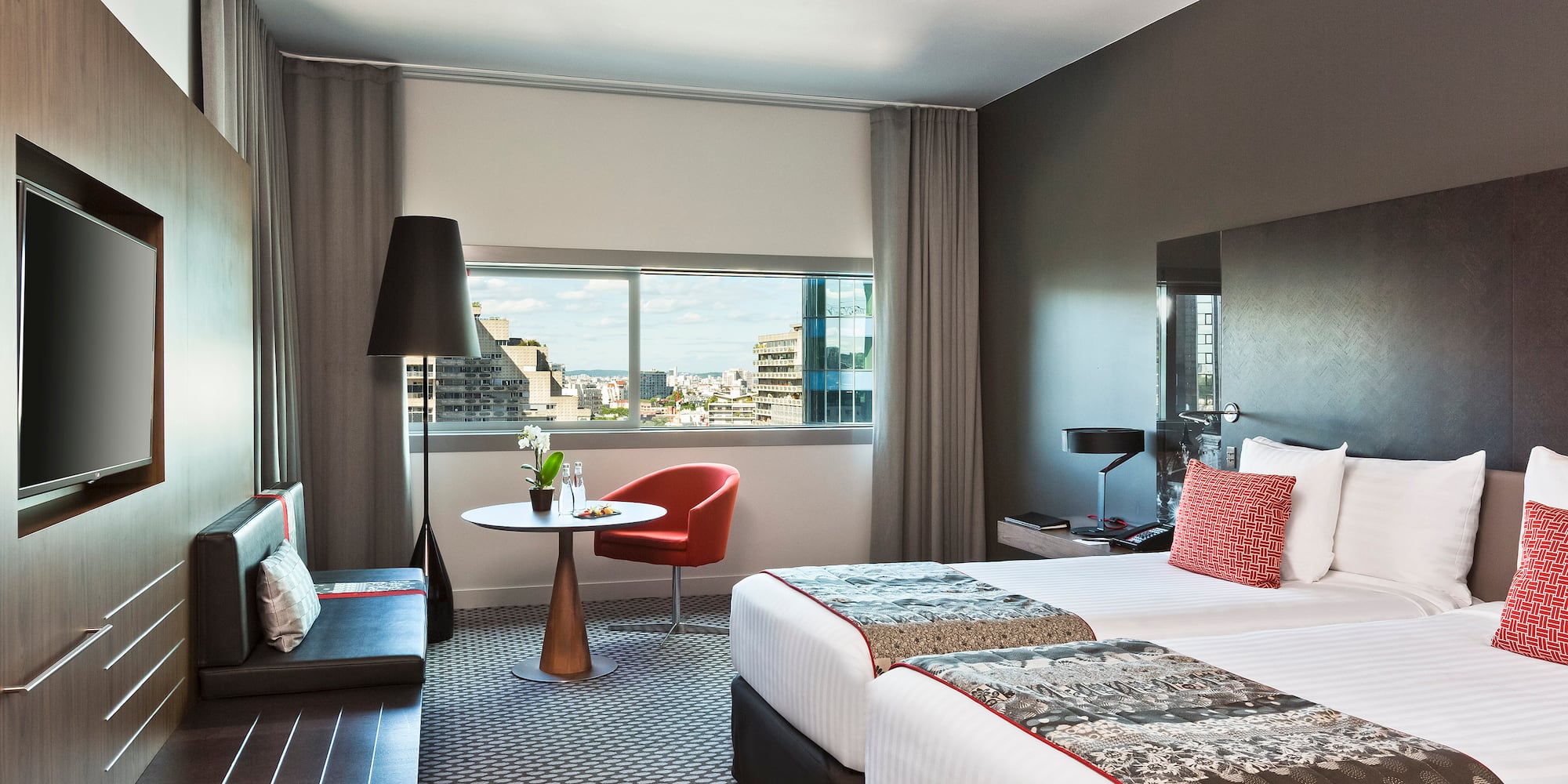 a room with two beds and a table