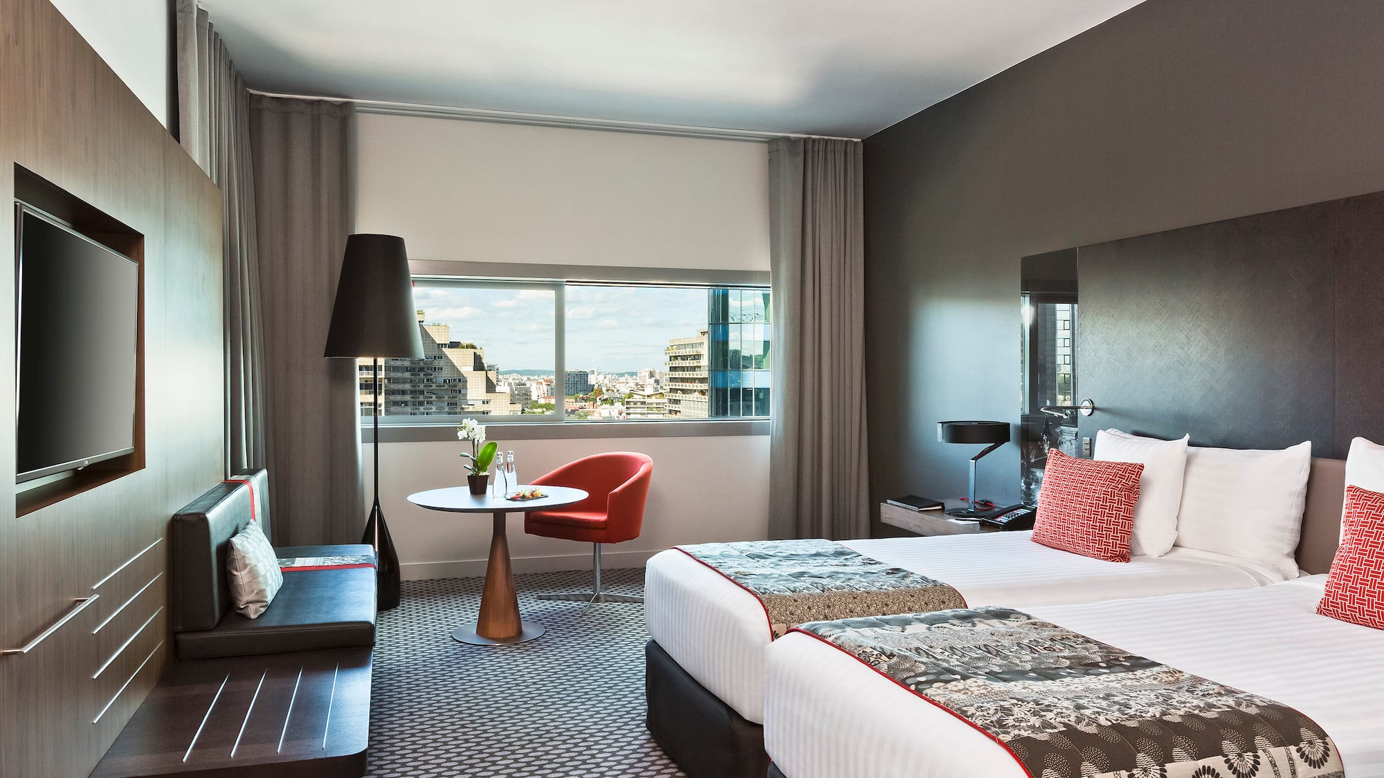 a room with two beds and a table