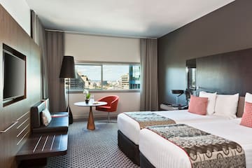 a room with two beds and a table