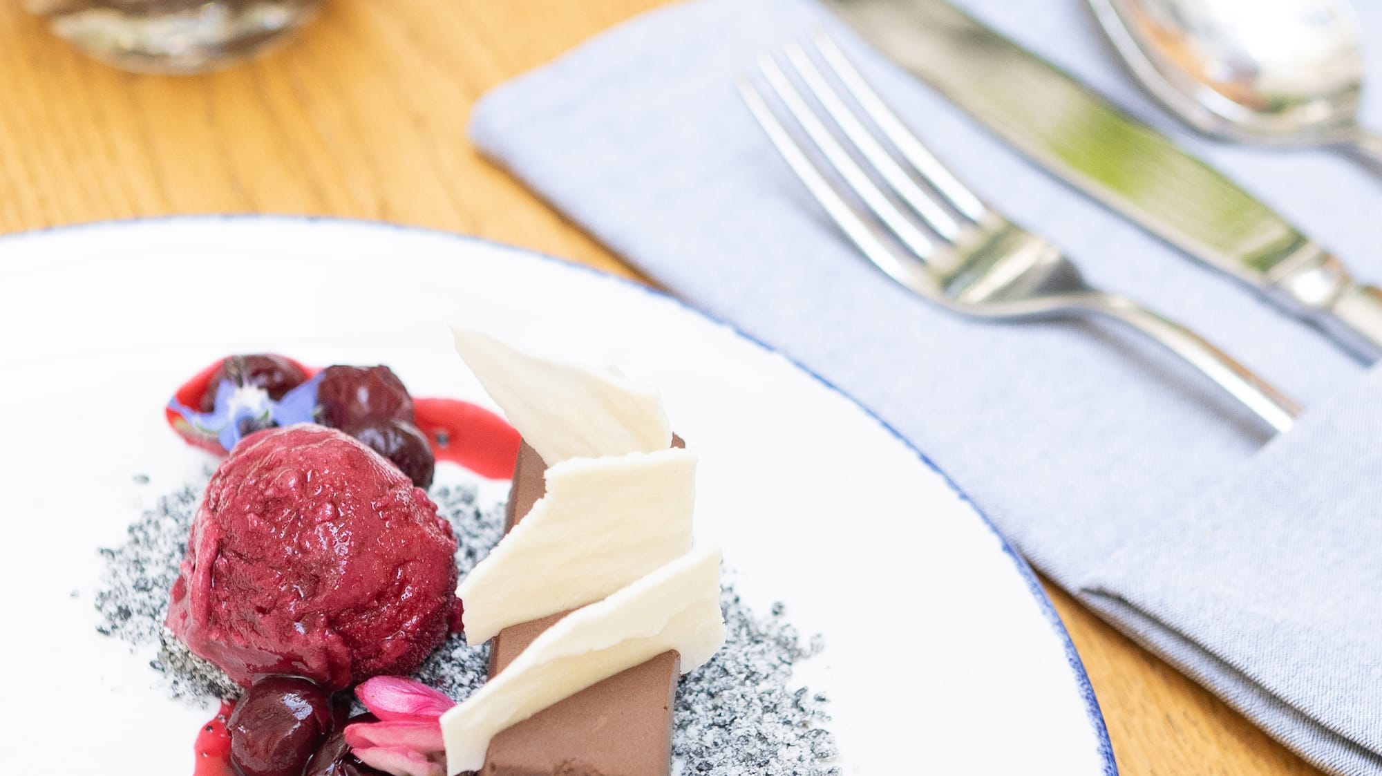 a plate of dessert with ice cream and berries