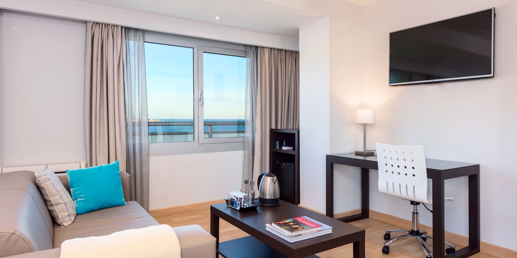 a room with a couch and a table and a television