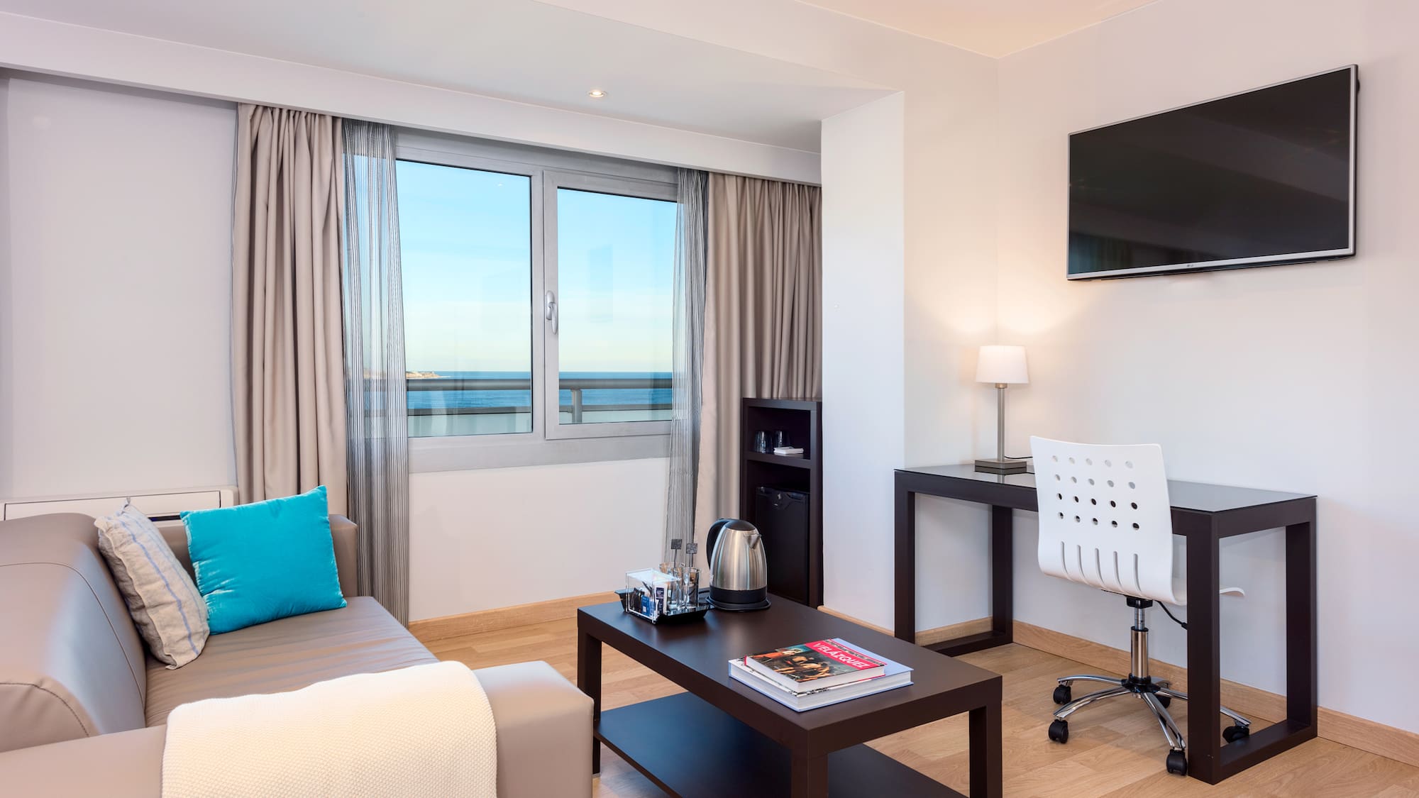 a room with a couch and a table and a television