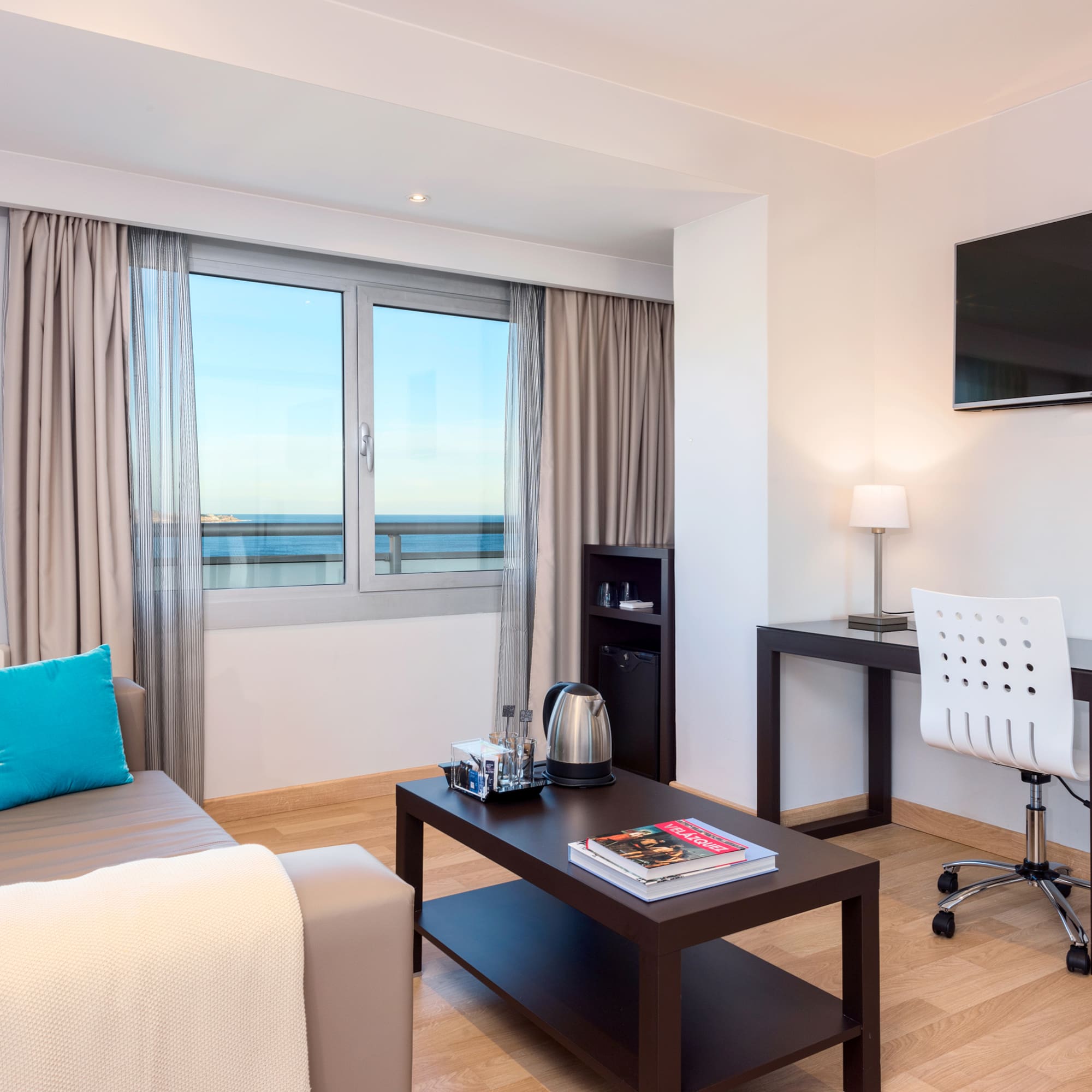 a room with a couch and a table and a television