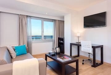 a room with a couch and a table and a television