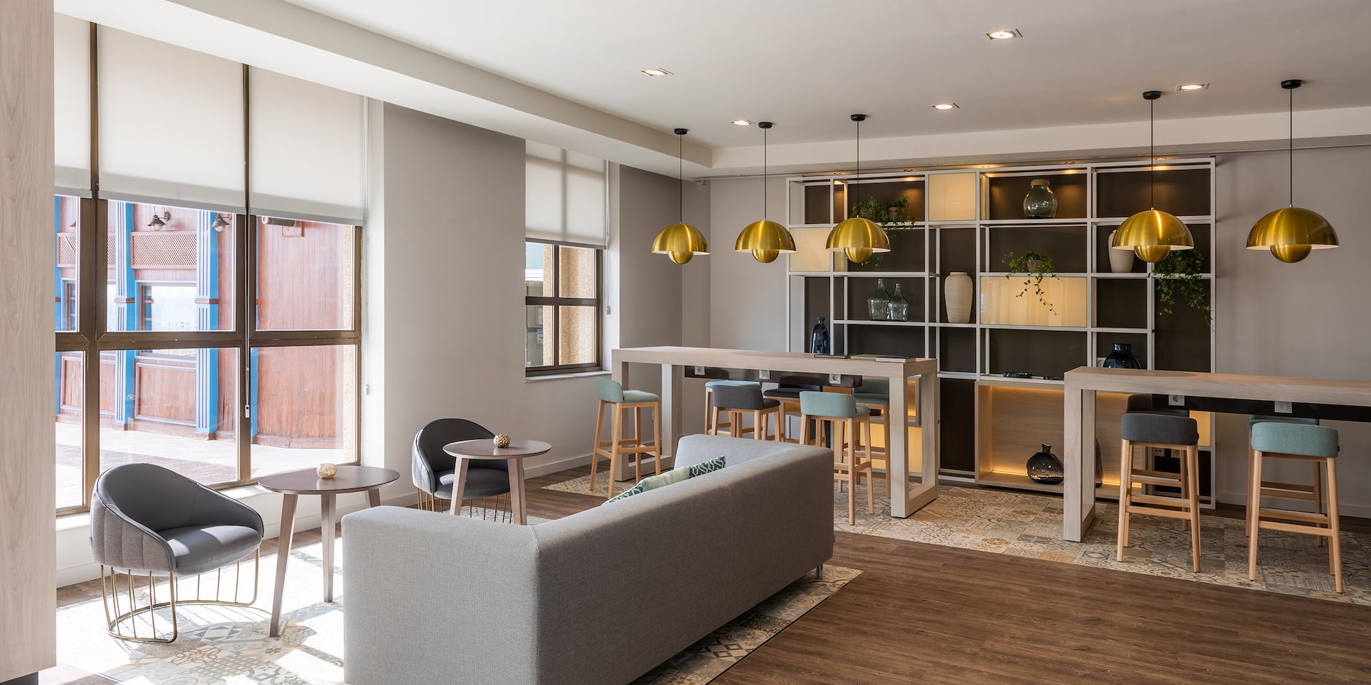 a room with a couch and tables and chairs