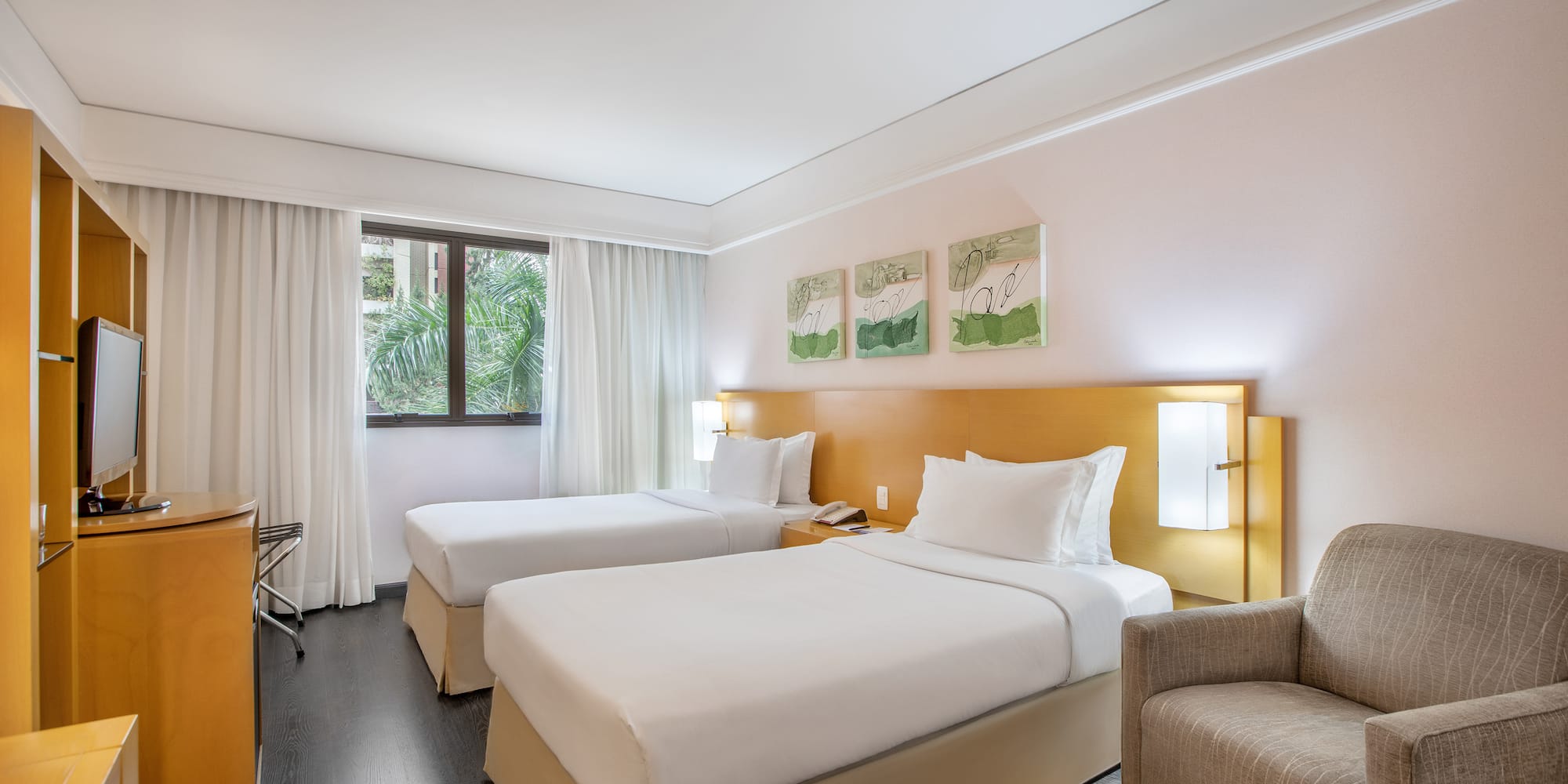 a room with two beds and a chair