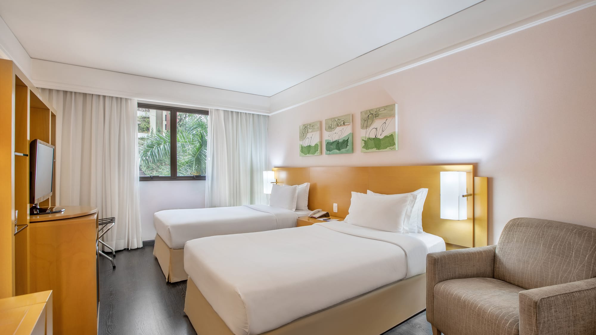 a room with two beds and a chair