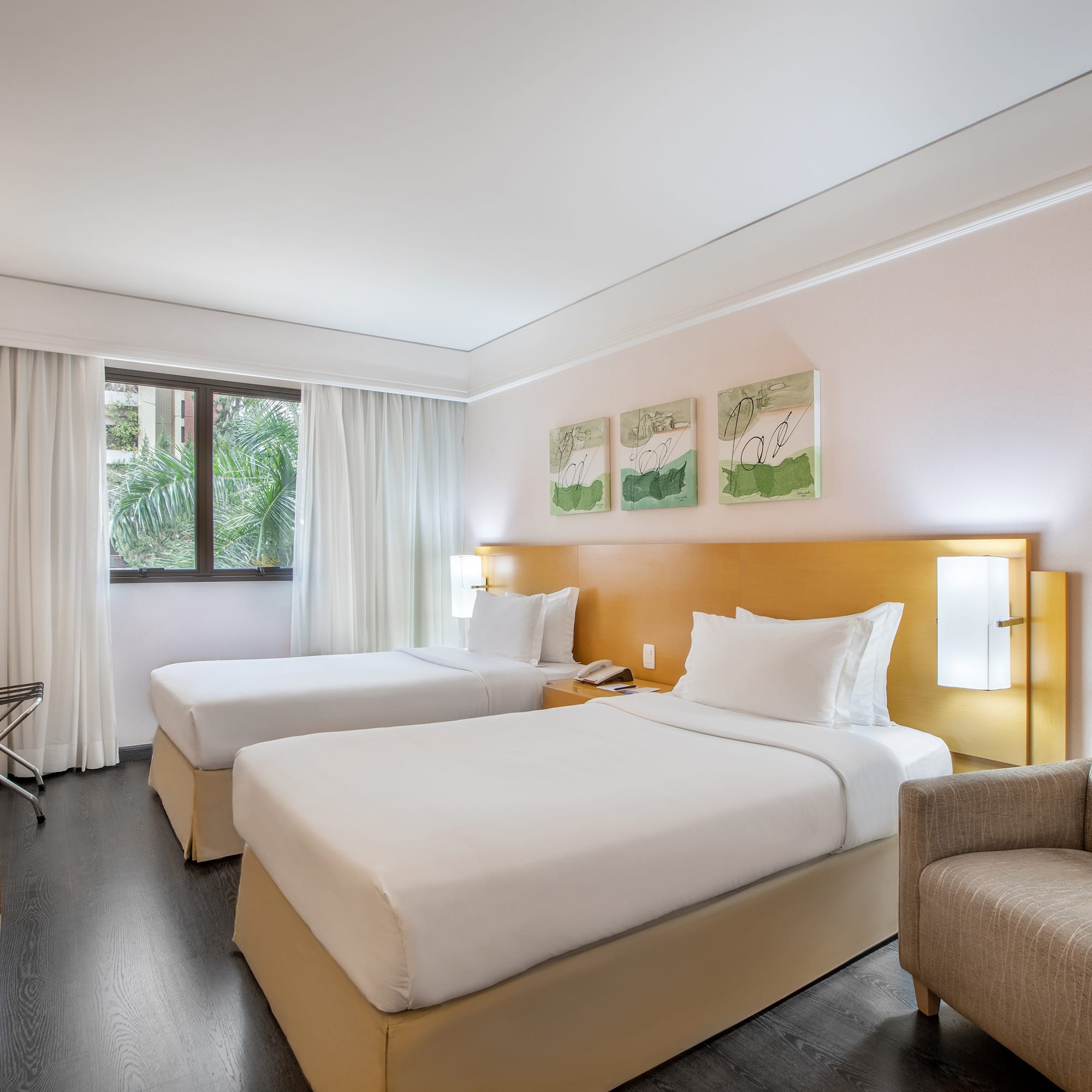 a room with two beds and a chair