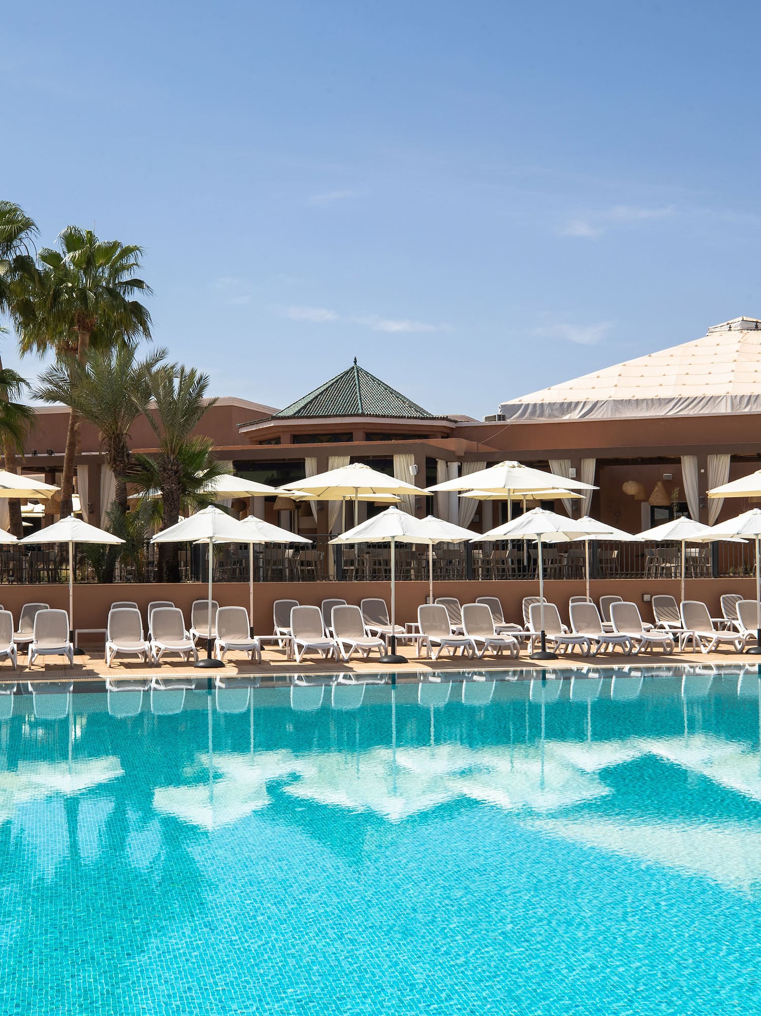a pool with umbrellas and chairs