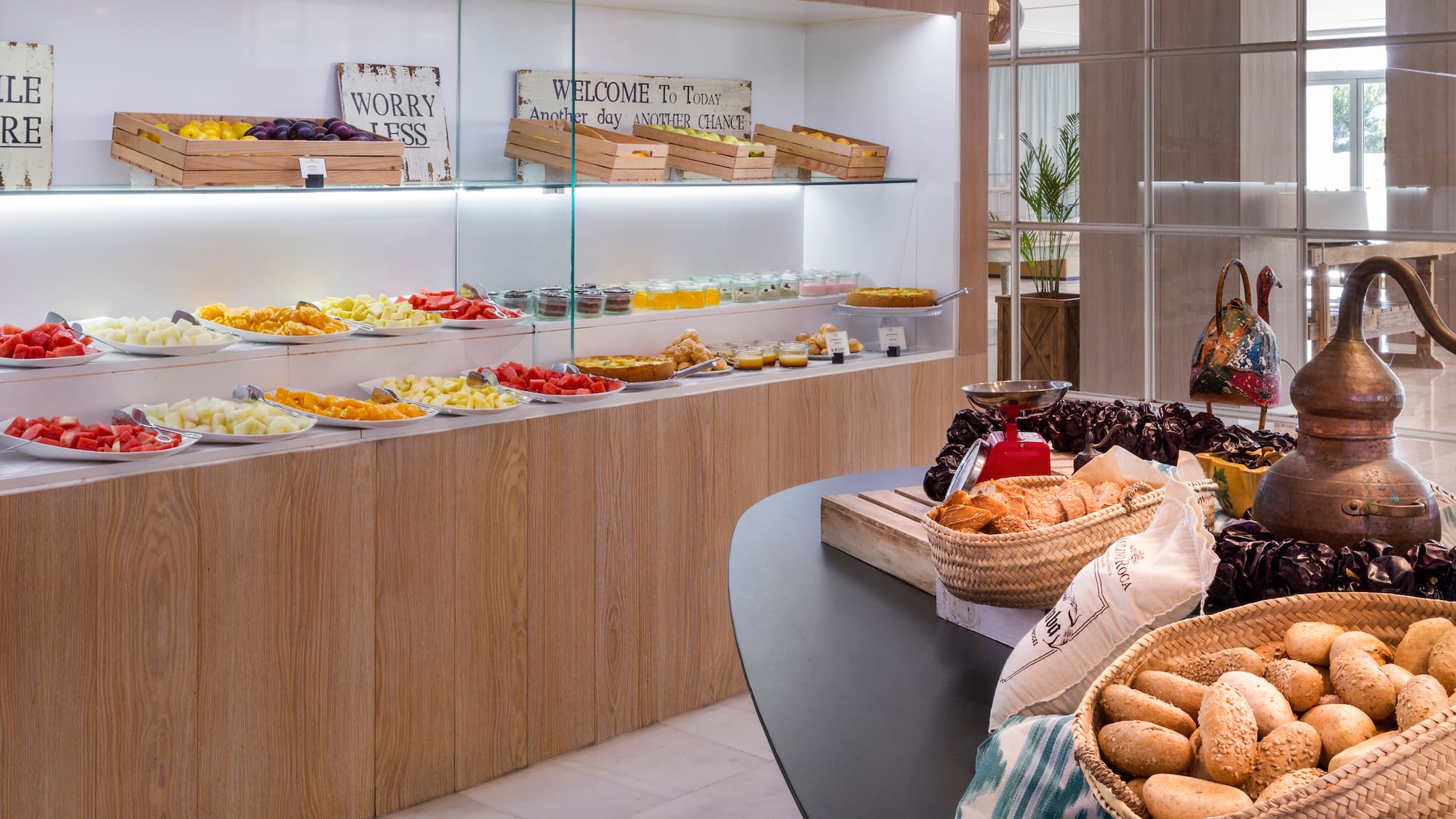 a woman standing in front of a counter with food