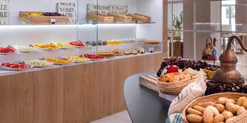 a woman standing in front of a counter with food