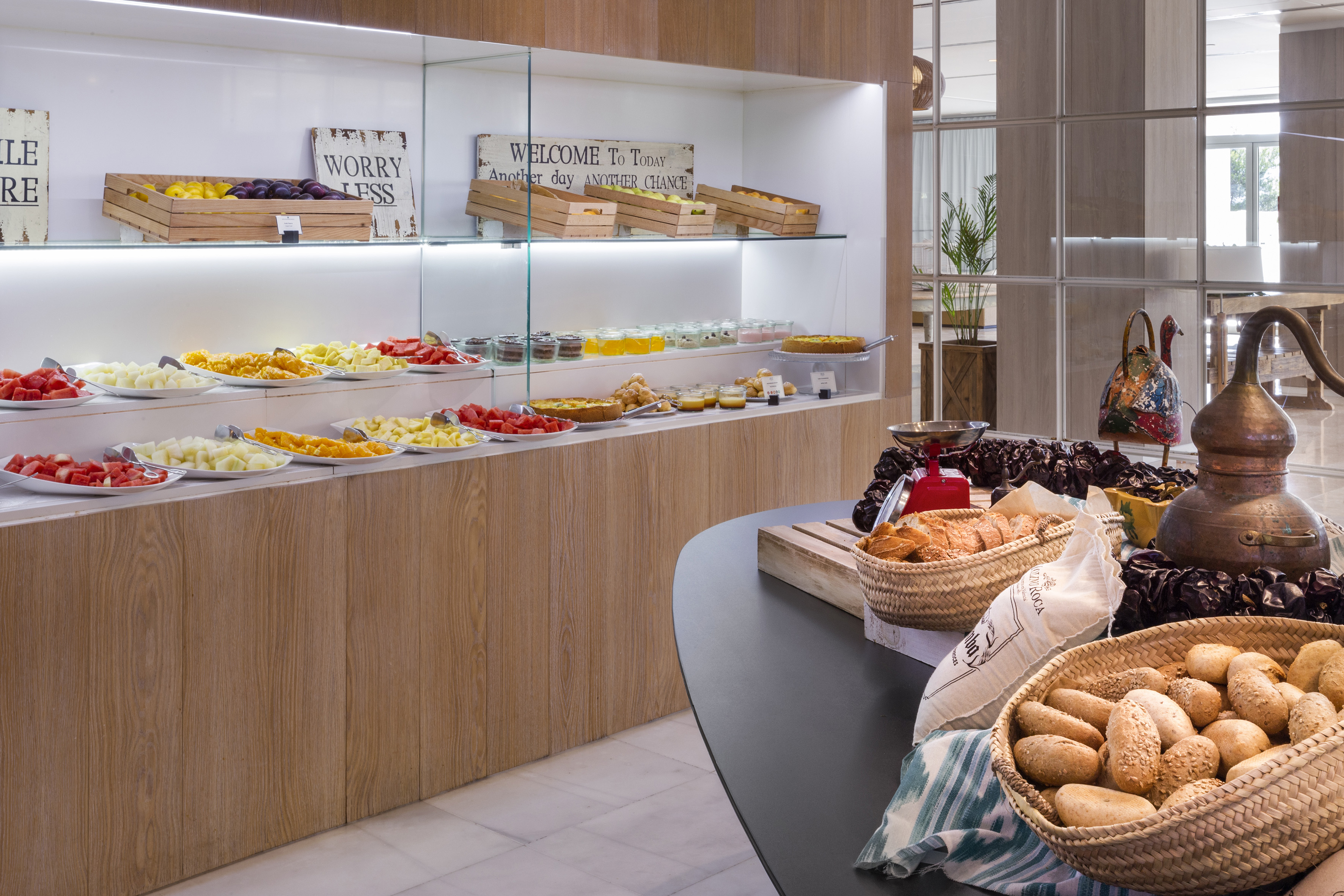 Hotel breakfast buffet with fresh fruit, pastries, and bread selection.