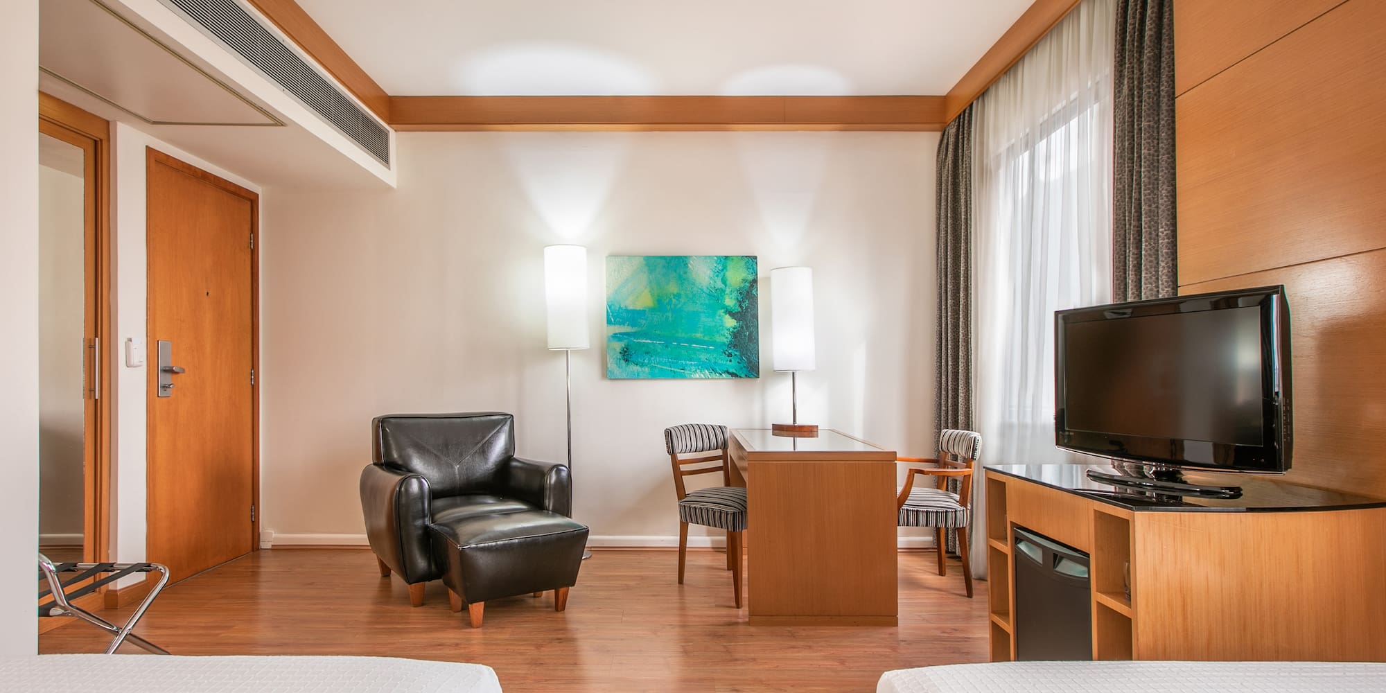 a room with two beds and a tv