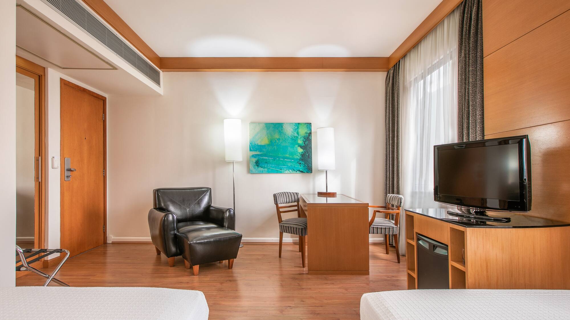 a room with two beds and a tv