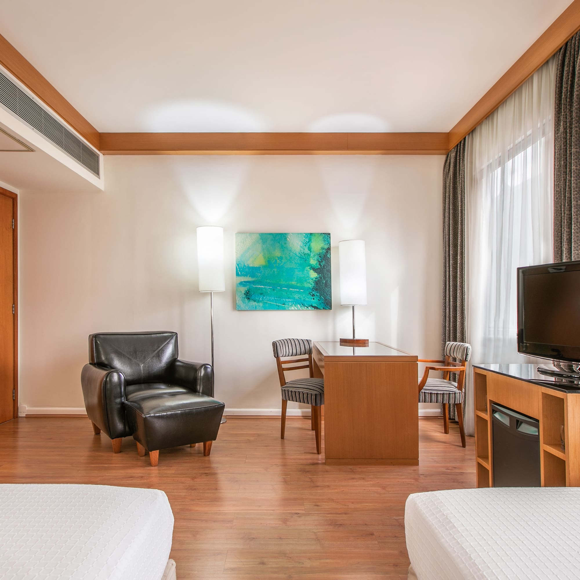 a room with two beds and a tv