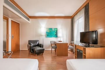 a room with two beds and a tv