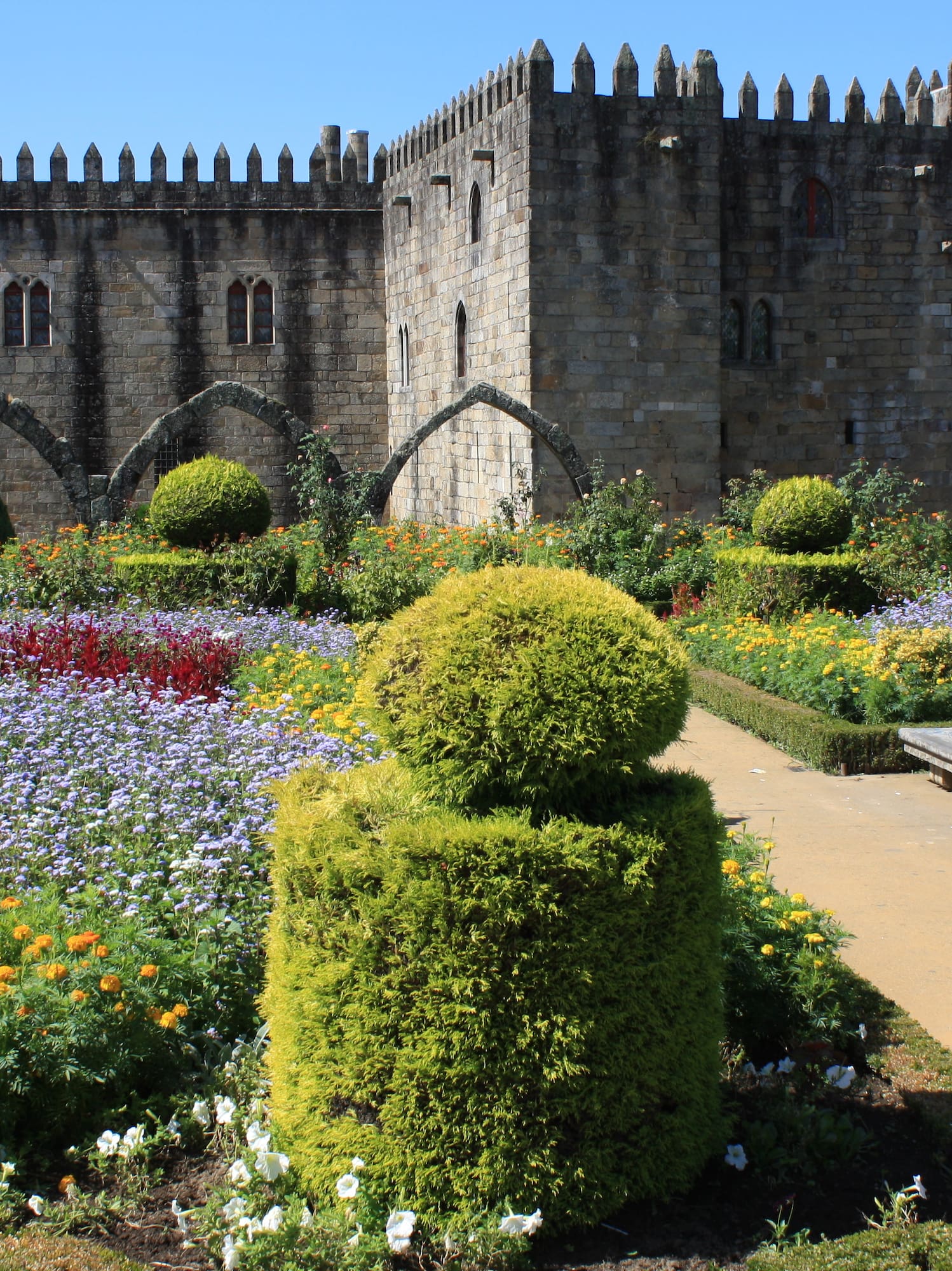a stone castle with a garden