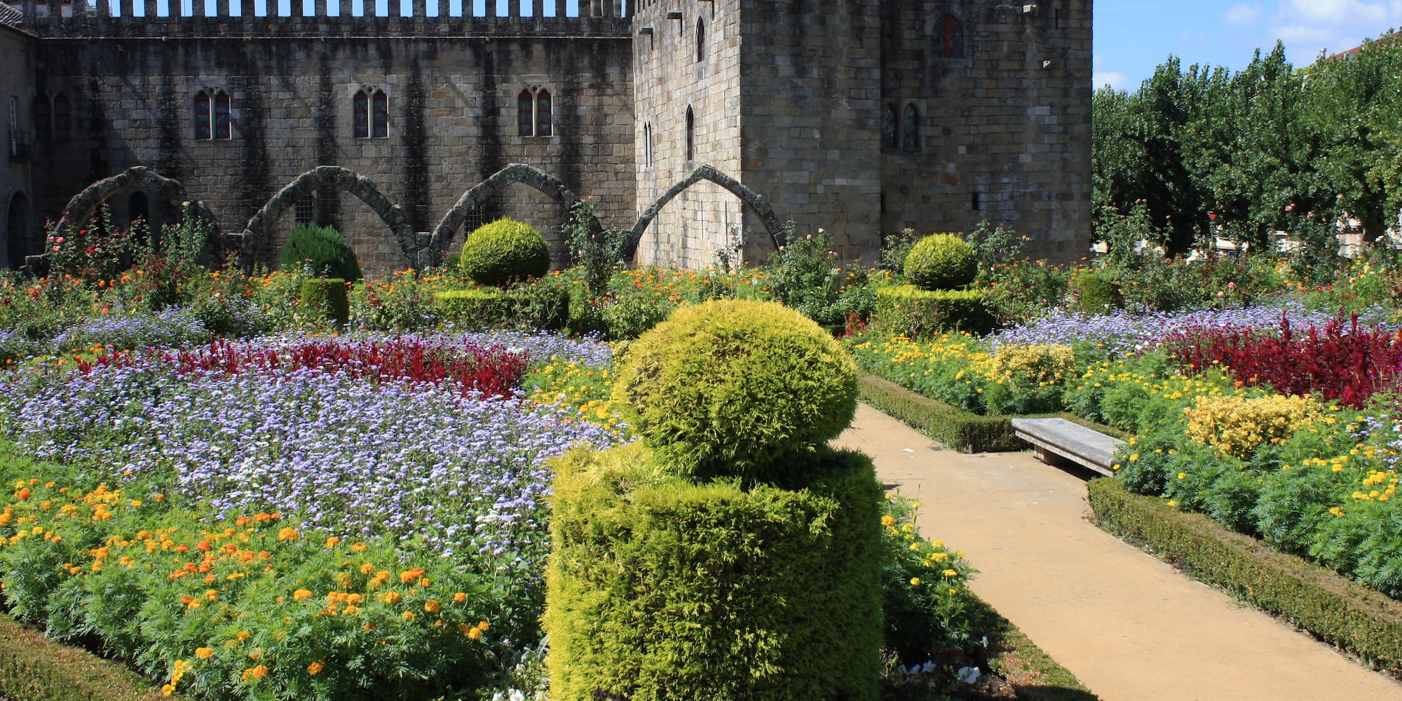 a stone castle with a garden