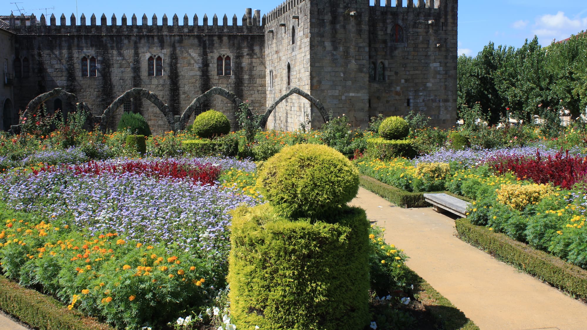 a stone castle with a garden