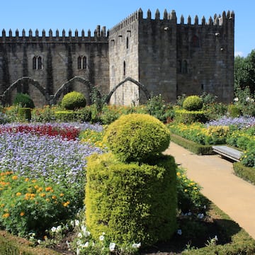 a stone castle with a garden