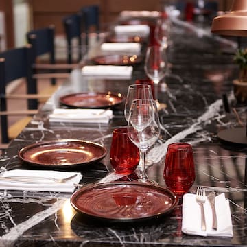 a long table with plates and glasses