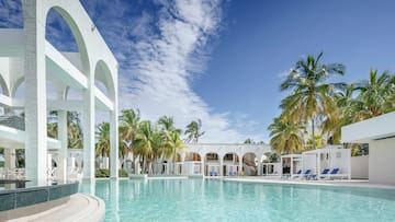a pool with palm trees and arches