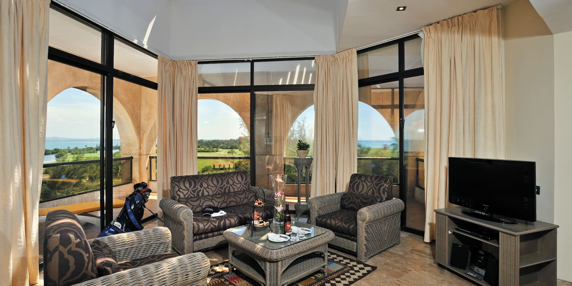 a living room with a glass roof and a television