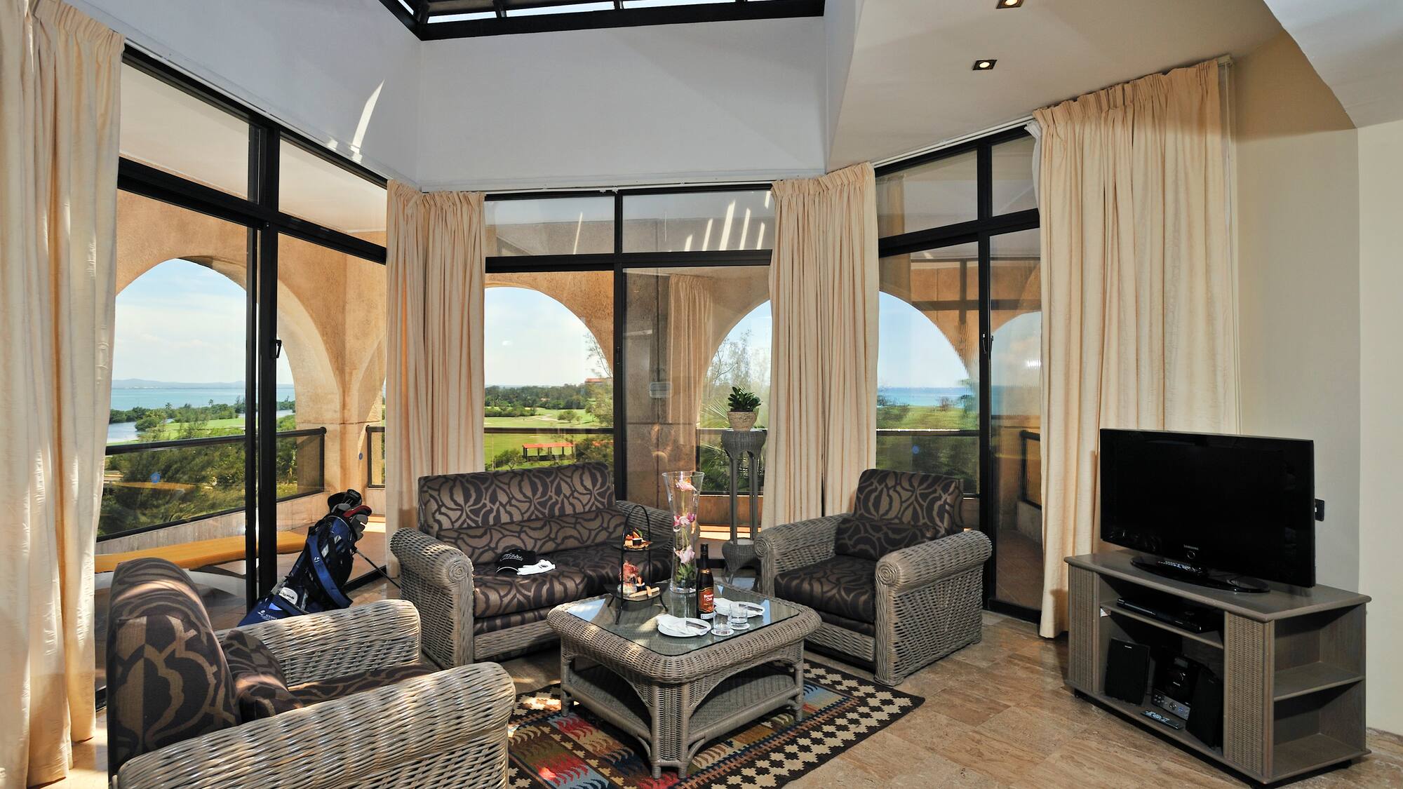 a living room with a glass roof and a television
