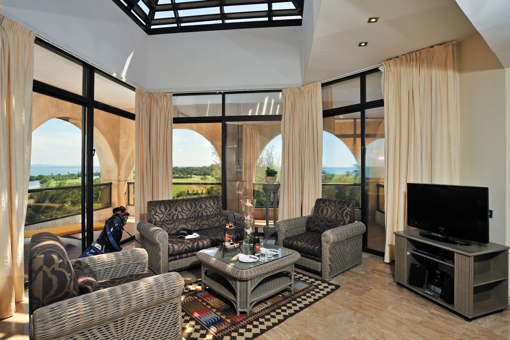 a living room with a glass roof and a television